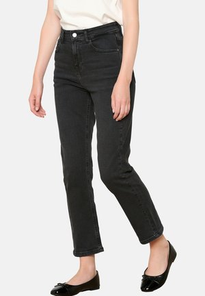 Black denim jeans with a fitted waist, straight legs, and subtle fading. Front pockets and a smooth texture, paired with black flats.