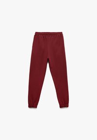 Bordeauxfarbene Sweatpants mit elastischem Bund, schmal zulaufendem Bein und gerippten Bündchen. Weicher Stoff mit glatter Textur, ohne sichtbare Muster oder Akzente.