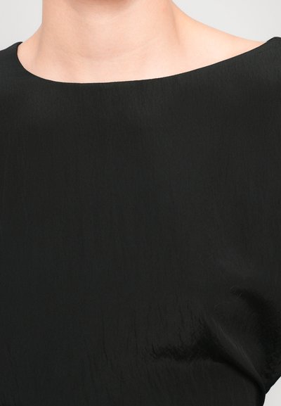 Black top with a smooth, slightly crinkled texture, featuring a wide, rounded neckline, and minimal design details.