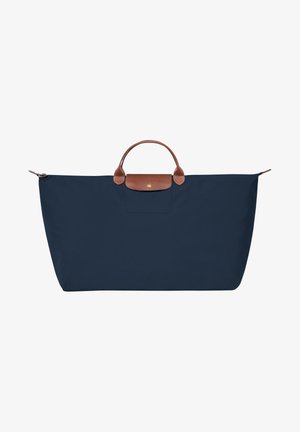 Navy blue tote bag with a rectangular shape, top handles, and a brown leather accent on the front. Made from durable fabric.