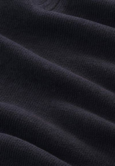 Dark navy fleece fabric with a soft, textured surface displaying gentle waves and ridges, providing a warm and cozy appearance.