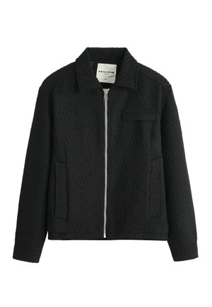 Veste zippée noire texturée avec col, deux poches latérales et une poche poitrine, présentée sur fond blanc.