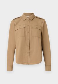 Langermet skjorte i beige stoff med knappelukking foran, to brystlommer, skulderklapper og buet kant.