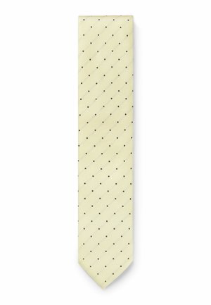 Lysegul slips med jævnt fordelte små sorte prikker, lavet af tekstureret stof, vist fladt på hvid baggrund.