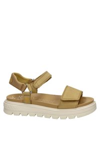 Las sandalias ajustables en color beige cuentan con un diseño de dos correas, una plantilla acolchada y una suela de goma texturizada blanca con un patrón de tracción.