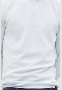 Camisa de manga larga de color azul claro, texturizada, con cuello redondo y costuras de hombro caídas, que incluye puños y dobladillo acanalados.