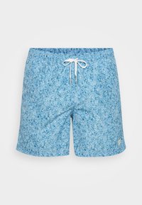 Sinine mustriline ujumispüksid on valmistatud tekstuuritud kangast, neil on elastne vöökoht ja valge nöör. Väike brändi silt alumises servas.