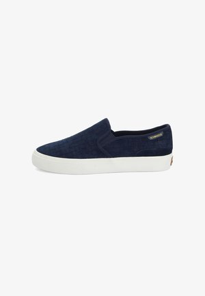 Navy slip-on shoes with a textured woven pattern, featuring a white rubber sole and a small gold label on the side.