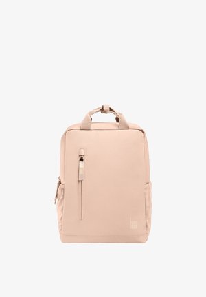 Kvadratisk beige rygsæk med topgreb, lodret lynlåslomme foran, sidelommer og diskret "GOT BAG"-logo nær nederste højre hjørne.