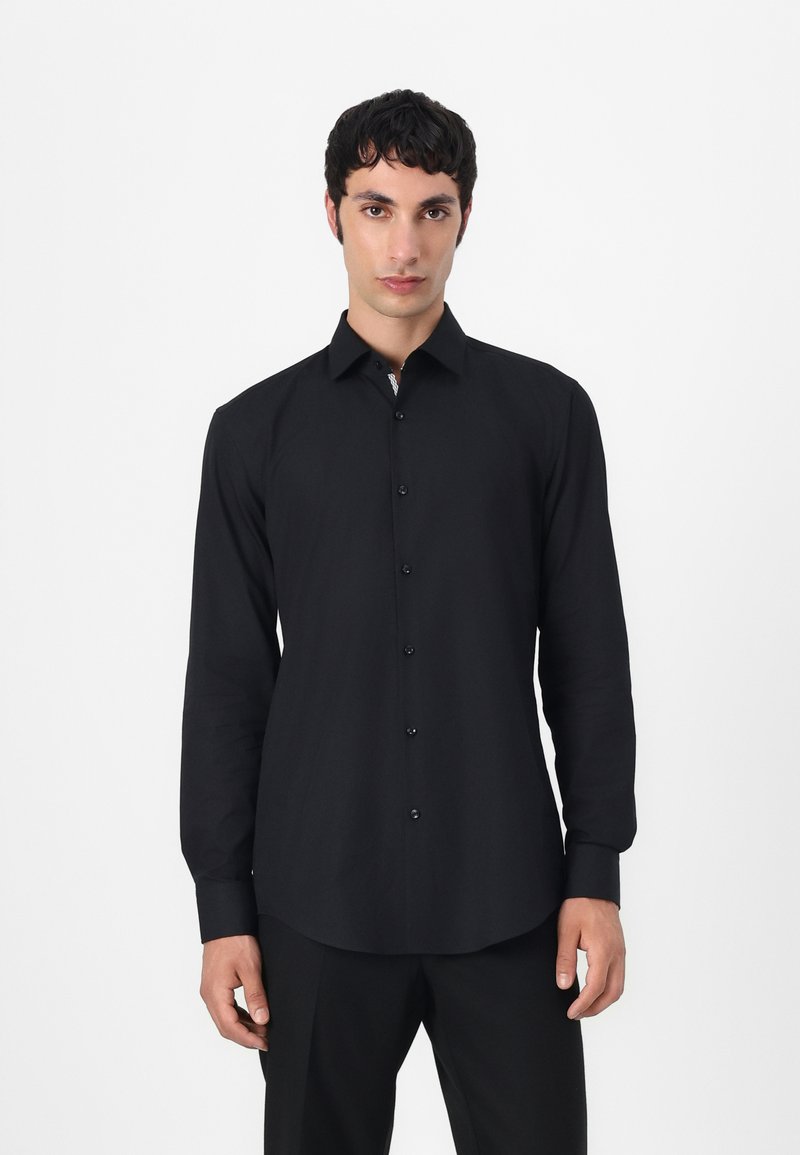 Black long-sleeve shirt with a button-down collar, featuring a smooth texture and matching buttons, tailored fit, and rounded hem.