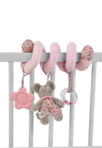 Soft pink fabric loops decorated with floral patterns hang from a crib. Features include a plush bear, a flower, and a textured rattle.