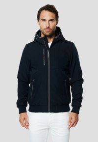 Marineblaue Zip-up-Jacke mit Kapuze, vorne Taschen, gerippte Bündchen und elastischer Saum. Mit Markenlogo auf der Vorderseite. Weiche Stoffstruktur.