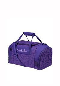 Purple duffel bag with a pattern of smiling faces, featuring dual handles, a shoulder strap, and a zippered closure. "Satch" logo on front.
