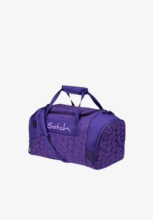 Purple duffel bag with a pattern of smiling faces, featuring dual handles, a shoulder strap, and a zippered closure. "Satch" logo on front.