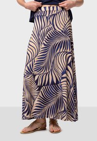 Maxikjol i marinblått och beige med ett lövmönster. Tillverkad av lättviktig tyg, med en mjuk textur och resårmidja.