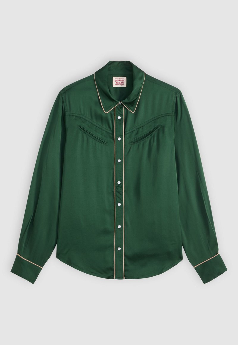 Green satin long-sleeve shirt with pointed collar, ivory piping, two chest pockets, and white buttons. Smooth texture with a polished finish.