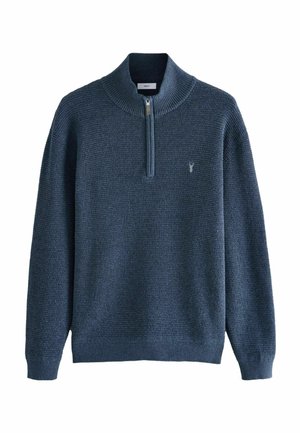 Pull-over en maille bleu marine avec un col zippé mi-hauteur, tissu texturé, poignets côtelés et détail de logo discret sur la poitrine.