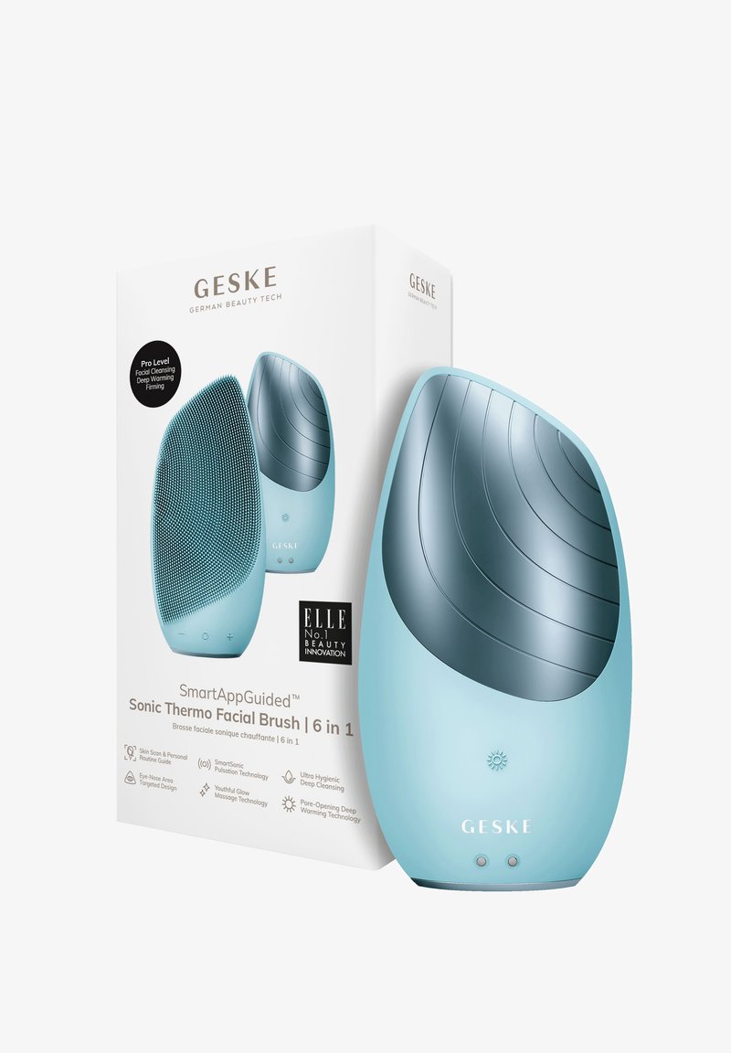 Sonic Thermo Gezichtsborstel in lichtblauw met textuurrubber haren en een glad, gebogen lichaam; verpakt in een witte doos met branding.