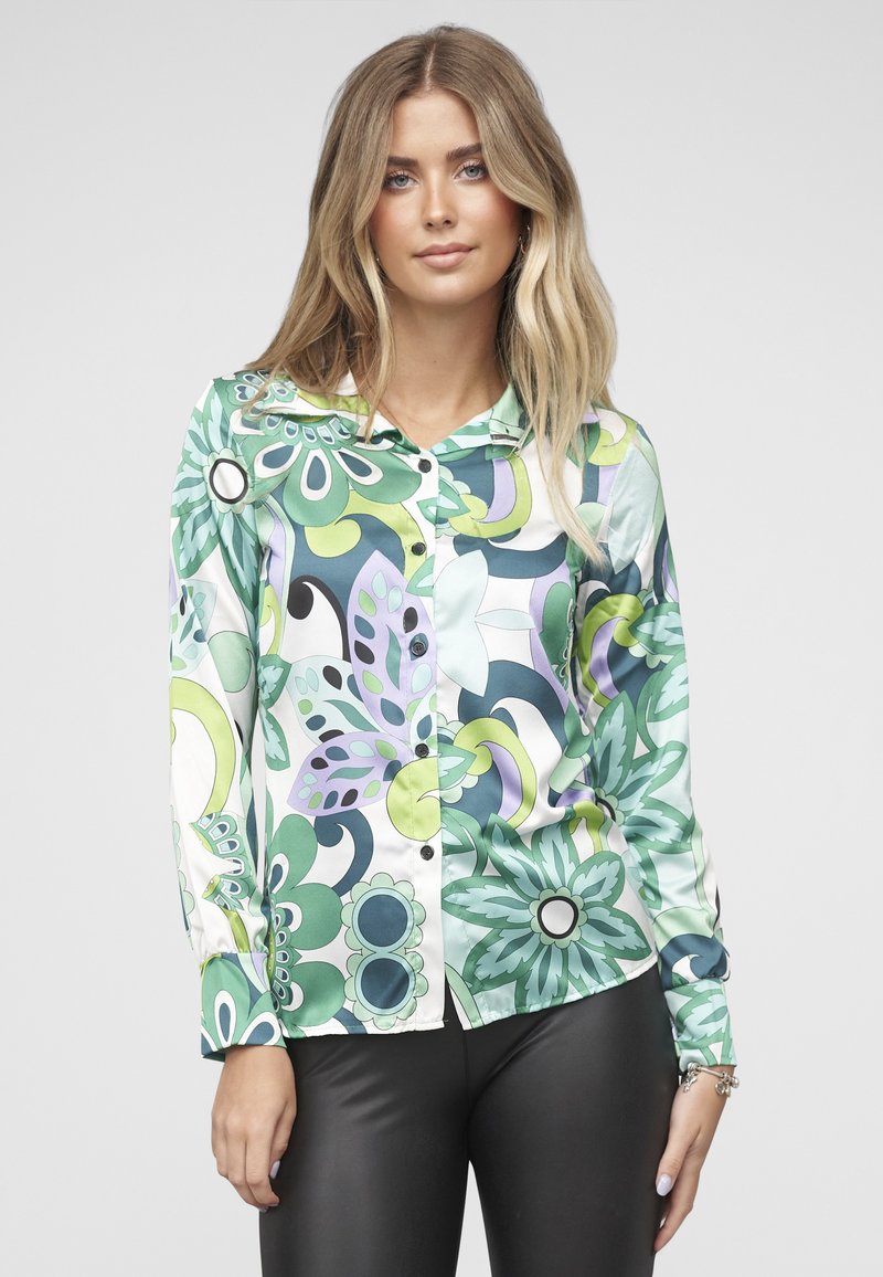 Košile s dlouhým rukávem z hladké látky s květinovým vzorem v zelené, modré a fialové barvě, s límečkem a zapínáním na knoflíky vpředu.