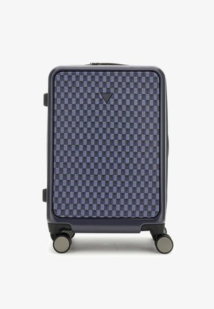 Hard-shell suitcase in dark navy with a patterned surface of interlocking squares in blue. Features a top handle and four multi-directional wheels.