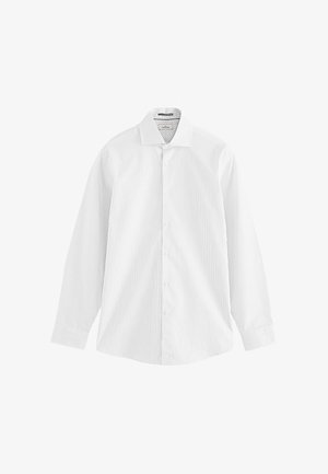 Bela srajca z dolgimi rokavi in tankimi navpičnimi črtami. Ima klasičen ovratnik in sprednje gumbe, izdelana je iz lahkotnega materiala.