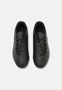 Schwarze Sportschuhe mit einer glatten, synthetischen Oberseite, Schnürdesign und strukturierten Details auf der Oberfläche. Gepolsterter Kragen und Zunge.