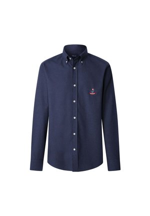 Camicia blu navy a maniche lunghe con colletto abbottonato e piccolo stemma ricamato sul lato sinistro del petto.