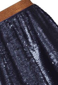 Granatowa spódnica z cekinami z błyszczącym brązowym elastycznym pasem. Charakteryzuje się błyszczącą strukturą i płynny design, odbijając światło pod różnymi kątami.