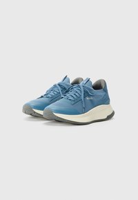 Blue athletic shoes with a textured fabric upper and grey accents. Thick beige sole for cushioning. Laces in matching blue color.