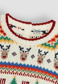 Neulepusero, jossa on kermaisa tausta, värikkäitä porokuvioita ja punainen ribbireunus. Puuvillasekoitetta, jossa on juhlallisia design-elementtejä.