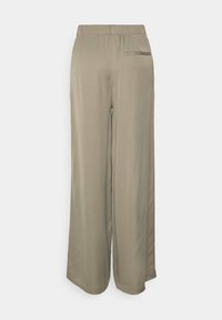 Light beige wide-leg pants made from smooth fabric. Features an elastic waistband and a single back pocket.