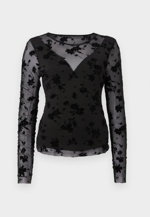 Svart langermet topp med et gjennomsiktig blomsterdesign, V-hals og samlet ermer. Stoffet har en myk, teksturert finish.