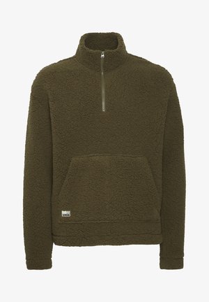 Alyvų žalios spalvos fliso megztinis su aukštu apykakle, ketvirčio užtrauktuku priekyje ir priekinėmis kengūros kišenėmis. Yra tekstūruotas audinys ir mažas logotipas apačioje.