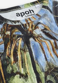 Close-up of a ribbed fabric tank top with an abstract blue, green, and brown pattern and a label reading "apoh London."