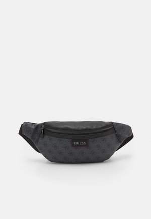 Dark gray Guess belt bag with monogram pattern, black top zipper pocket, and adjustable black strap on a white background.