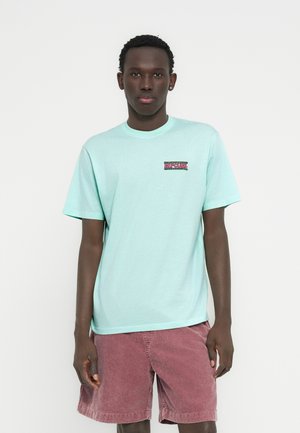 Mint green cotton t-shirt with short sleeves and a crew neck. Features a small multicolored "Rip Curl" logo on the left chest.