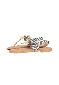 Sandali intrecciati con motivo a zigzag nero e bianco, soletta e cinturini in pelle marrone, con nappine decorative e fibbia regolabile.