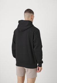 Champion GRAPHIC HOODIE - Džemperis ar kapuci - black
