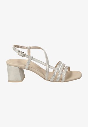 Silver strappy sandal featuring a block heel, open toe, and textured straps. The upper is metallic, with a smooth, beige insole.