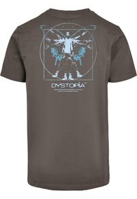 Brown t-shirt featuring a blue graphic of a figure with butterfly wings. Text reads "DYSTOPIA" and a phrase about justice and truth.
