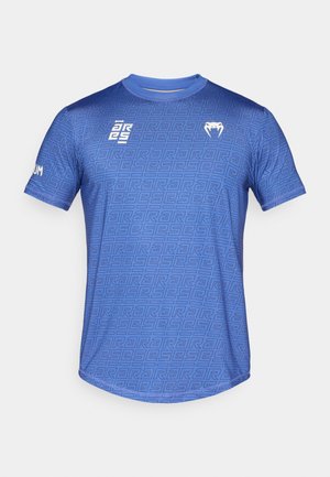 Camiseta deportiva azul con un patrón geométrico, cuello redondo, mangas cortas y logotipos blancos contrastantes en el pecho y la manga.