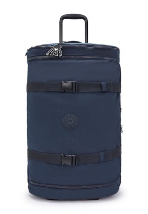 Navy fabric travel backpack with retractable handle, zippered compartments, and adjustable straps. Features a logo patch and smooth texture.