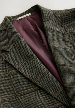 Green and brown plaid blazer with wide lapels and purple satin inner lining.