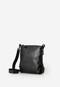 Schwarze Leder-Umhängetasche mit verstellbarem Riemen, Reißverschlussverschluss und glatter, strukturierter Oberfläche vor weißem Hintergrund.