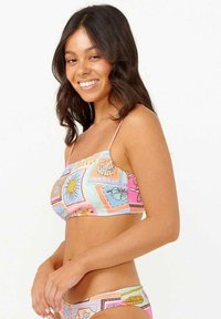 Top de bikini multicolor con tirantes finos, que presenta un patrón divertido de sol, conchas marinas y flores sobre un fondo pastel.