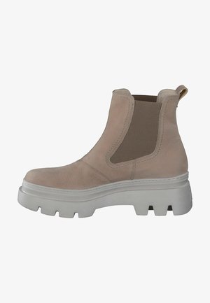 Bottes chelsea en cuir beige avec des panneaux élastiques sur les côtés et une semelle blanche épaisse. Présente une surface texturée et une languette à l'arrière.