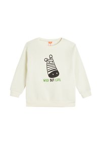 Felpa color crema con maniche lunghe, che presenta una grafica di zebra nera e un testo verde con la scritta "WILD BUT CUTE" sul davanti.
