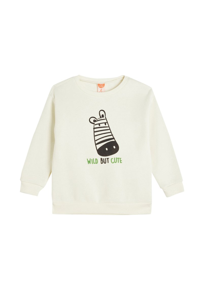 Felpa color crema con maniche lunghe, che presenta una grafica di zebra nera e un testo verde con la scritta "WILD BUT CUTE" sul davanti.