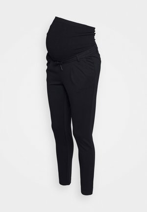 Black maternity pants with stretchy waistband and slim tapered legs shown on mannequin from side view.