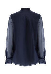 Navy blue blouse featuring sheer long sleeves, a textured collar, and a curved hem. Delicate fabric with subtle sheen and button accents.